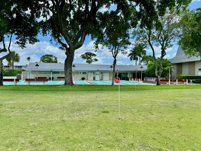 a view of an house with backyard space and balcony