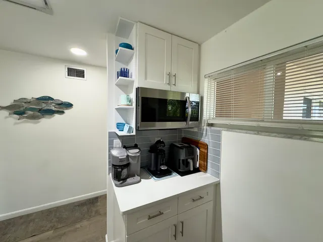 a kitchen with a sink and a stove top oven