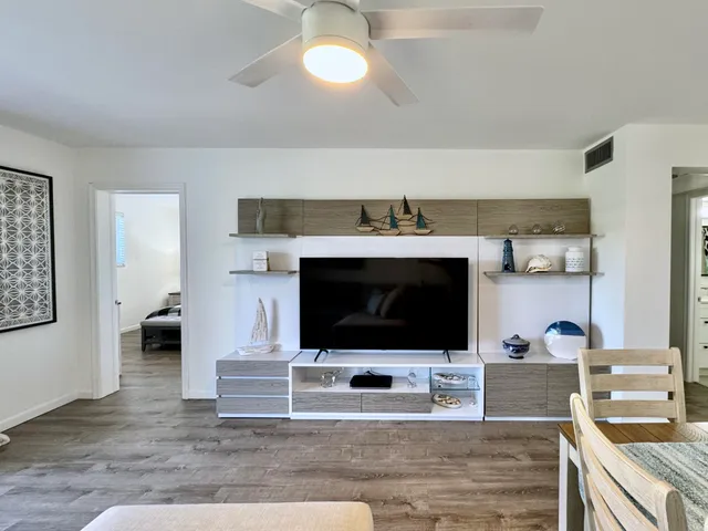 a living room with fireplace and a flat screen tv