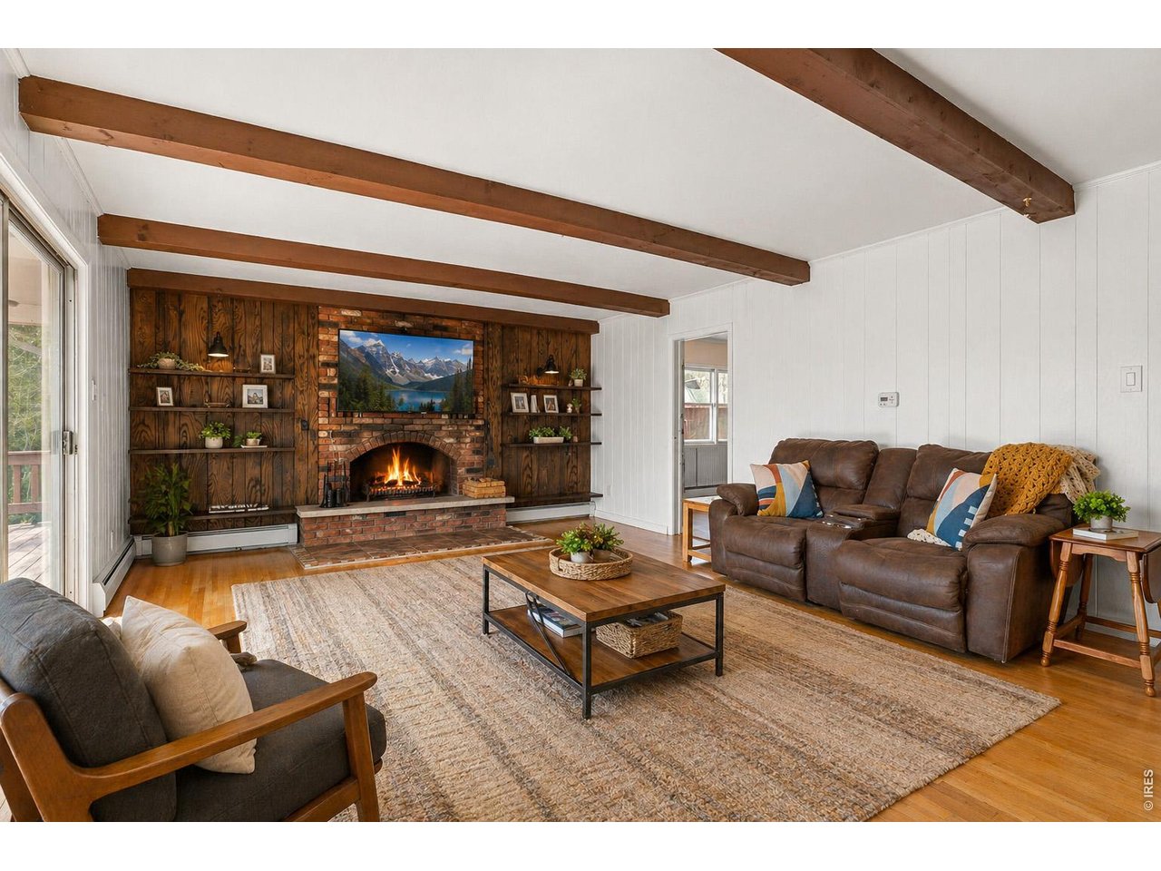 418 Athena Road Black Hawk, CO 80422 - Photo 13 of 40 Main level living room with wood fireplace