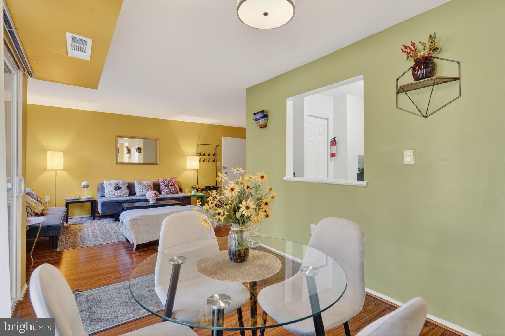 3850 Bel Pre Road, Unit 38504 Silver Spring, MD 20906 - Photo 12 of 15 a dining room with furniture and wooden floor