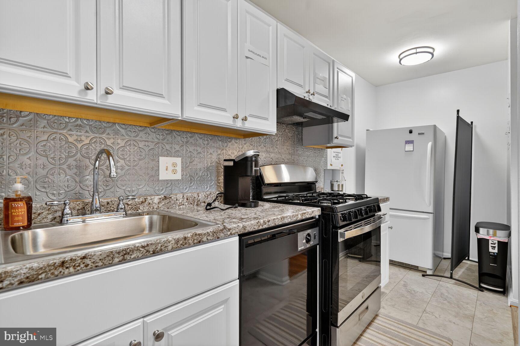 3850 Bel Pre Road, Unit 38504 Silver Spring, MD 20906 - Photo 2 of 15 a kitchen with stainless steel appliances granite countertop a sink stove and refrigerator