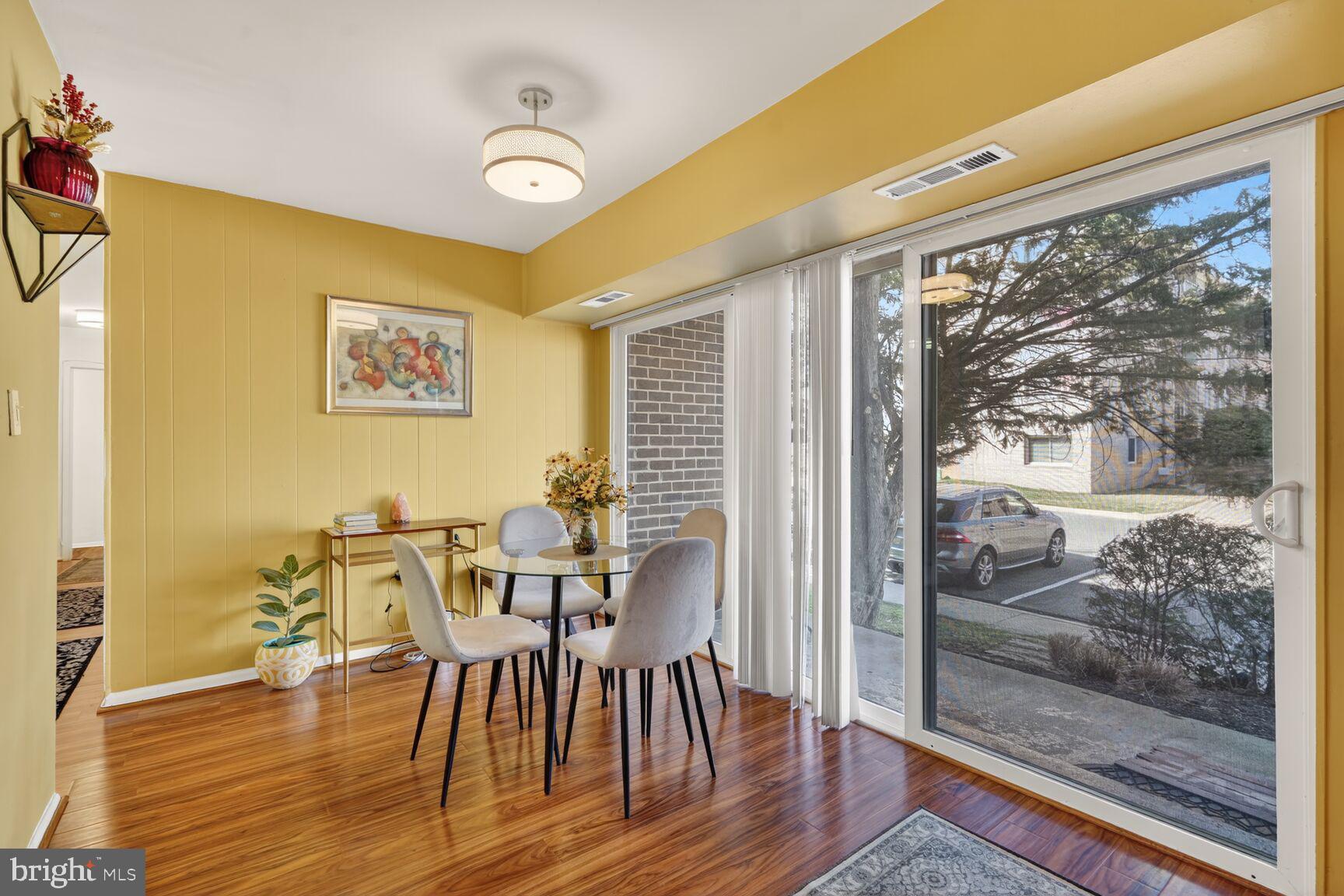3850 Bel Pre Road, Unit 38504 Silver Spring, MD 20906 - Photo 3 of 15 a view of a dining room with furniture and wooden floor