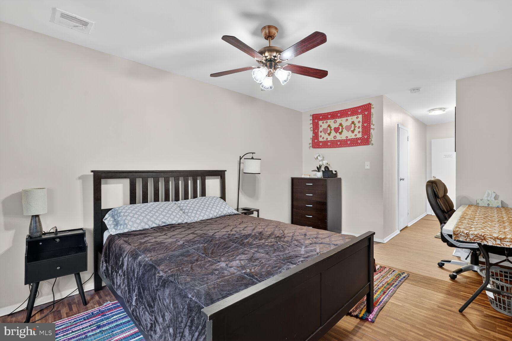 3850 Bel Pre Road, Unit 38504 Silver Spring, MD 20906 - Photo 4 of 15 a bedroom with a bed and a chandelier