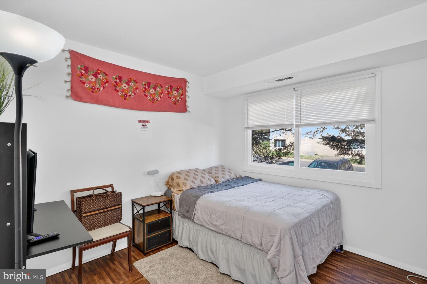 3850 Bel Pre Road, Unit 38504 Silver Spring, MD 20906 - Photo 7 of 15 a bedroom with a bed and a painting on the wall