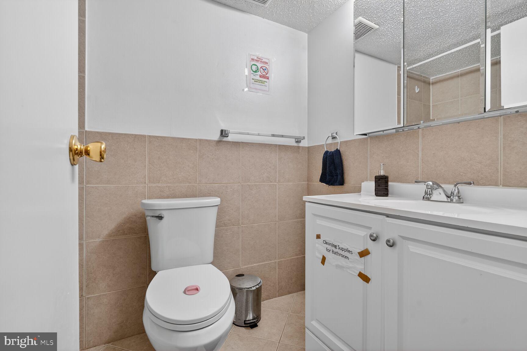 3850 Bel Pre Road, Unit 38504 Silver Spring, MD 20906 - Photo 8 of 15 a bathroom with a toilet sink and mirror