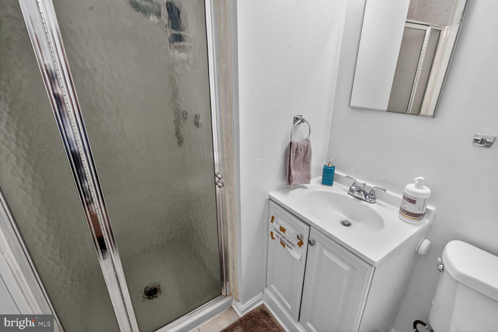 3850 Bel Pre Road, Unit 38504 Silver Spring, MD 20906 - Photo 9 of 15 a bathroom with a sink a toilet and shower