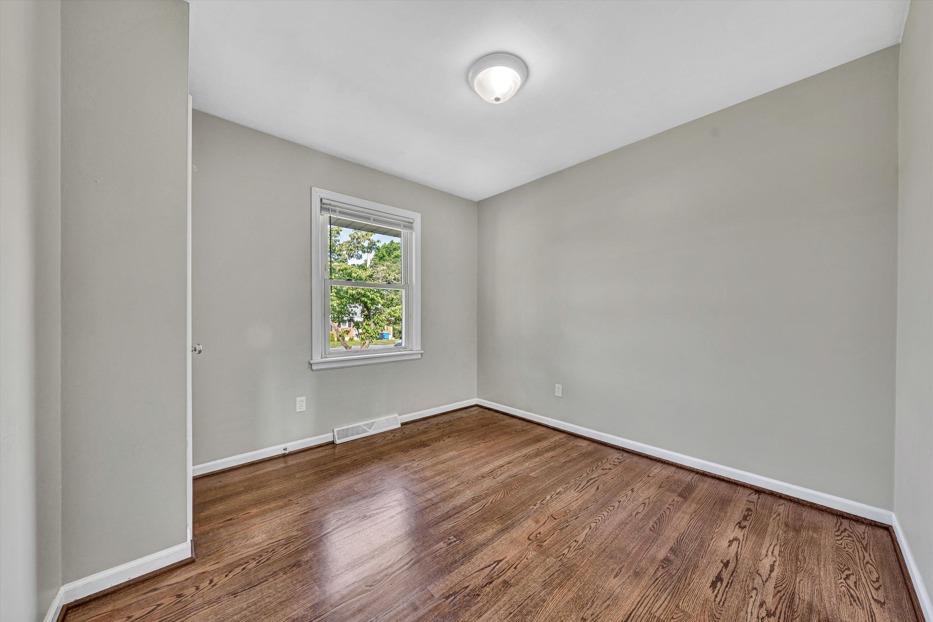 5225 Florist Road Roanoke, VA 24012 - Photo 12 of 38 an empty room with wooden floor and windows