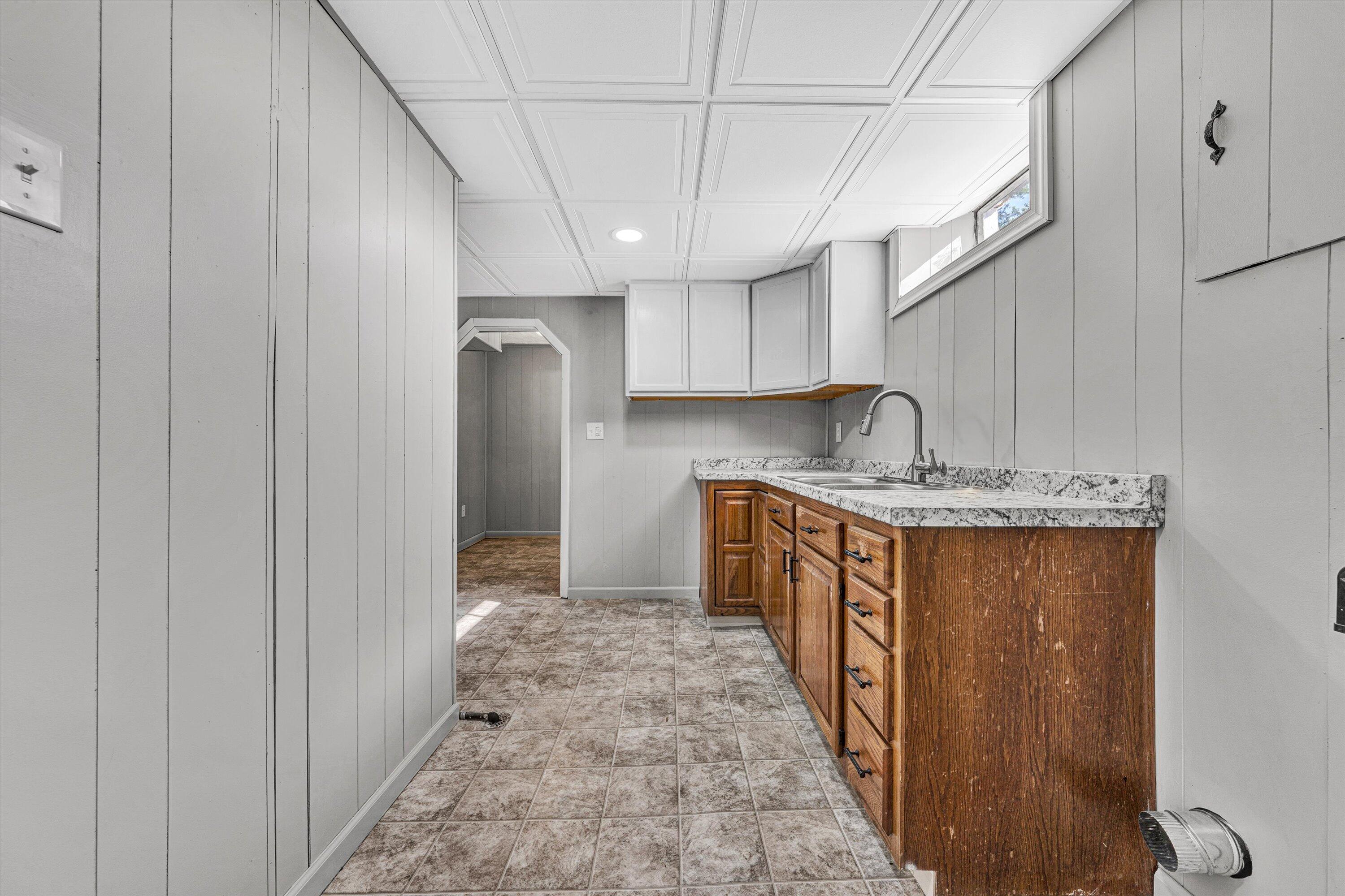 5225 Florist Road Roanoke, VA 24012 - Photo 20 of 38 a kitchen with granite countertop a sink a counter top space and cabinets