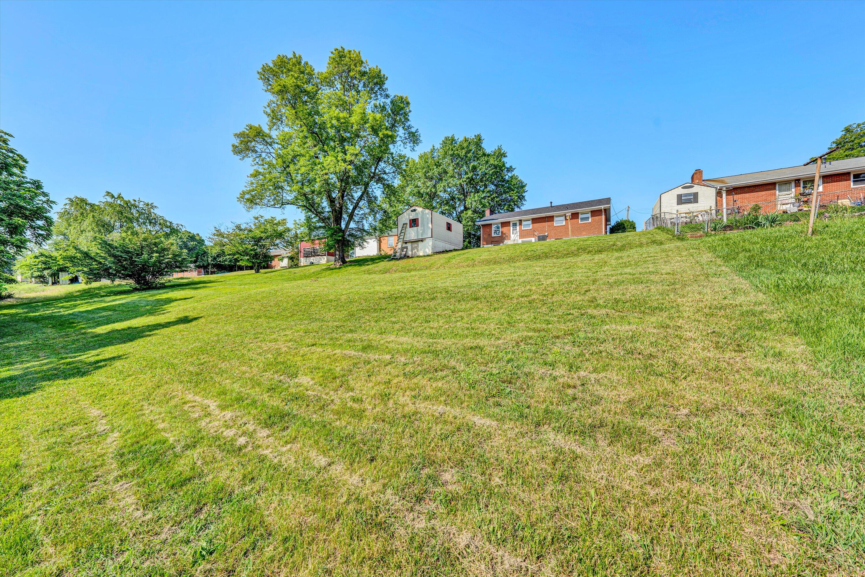 5225 Florist Road Roanoke, VA 24012 - Photo 35 of 38 a yellow house with garden in front of it