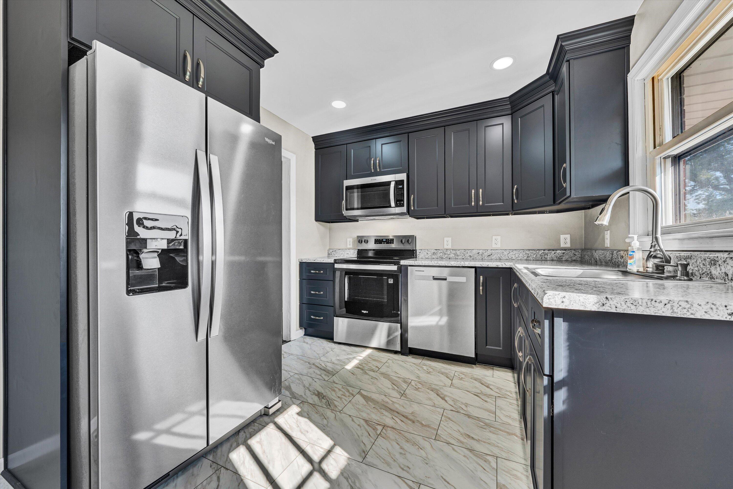 5225 Florist Road Roanoke, VA 24012 - Photo 8 of 38 a kitchen with granite countertop a refrigerator stove and sink