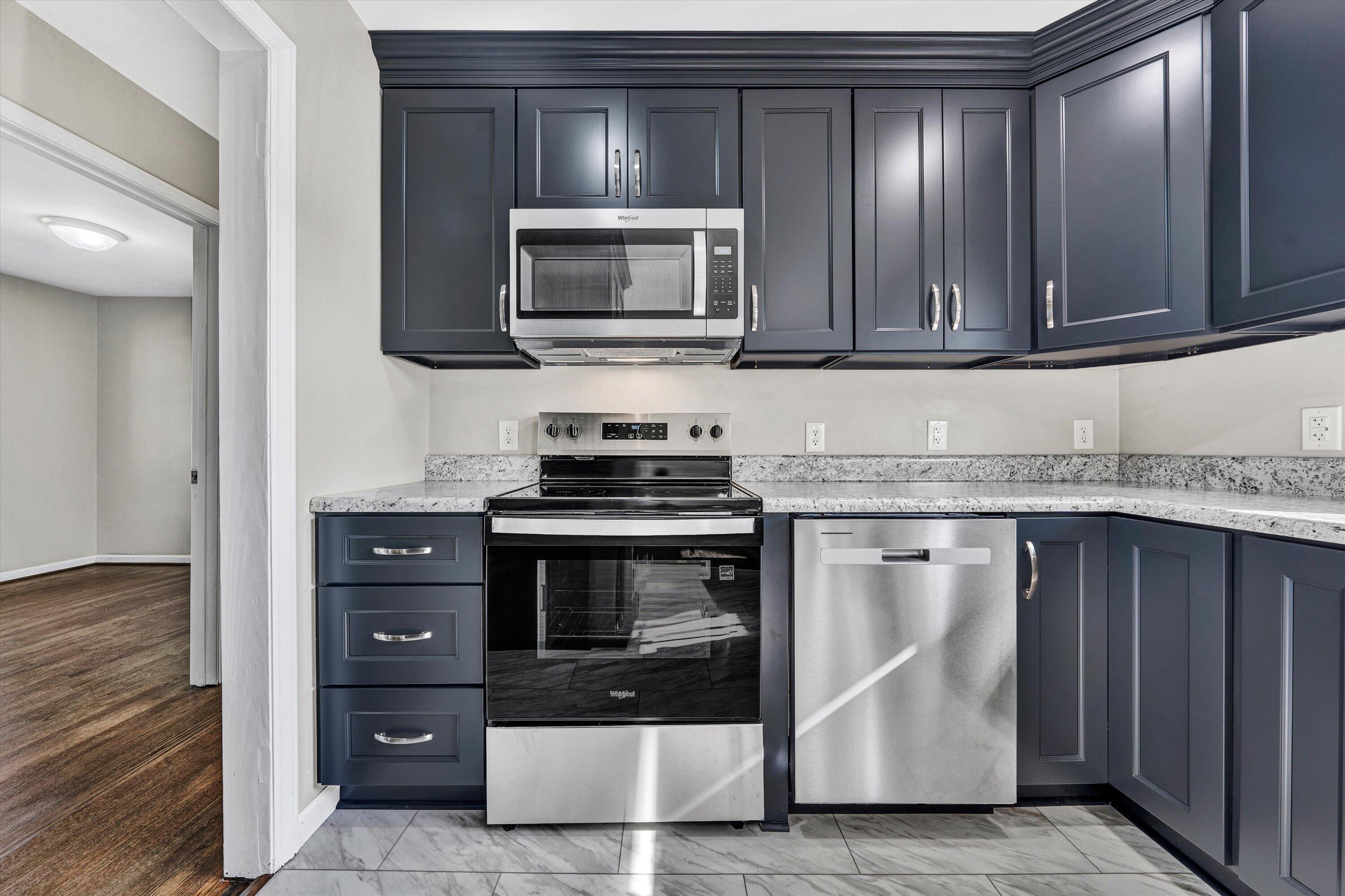 5225 Florist Road Roanoke, VA 24012 - Photo 9 of 38 a kitchen with stainless steel appliances granite countertop a stove microwave and cabinets