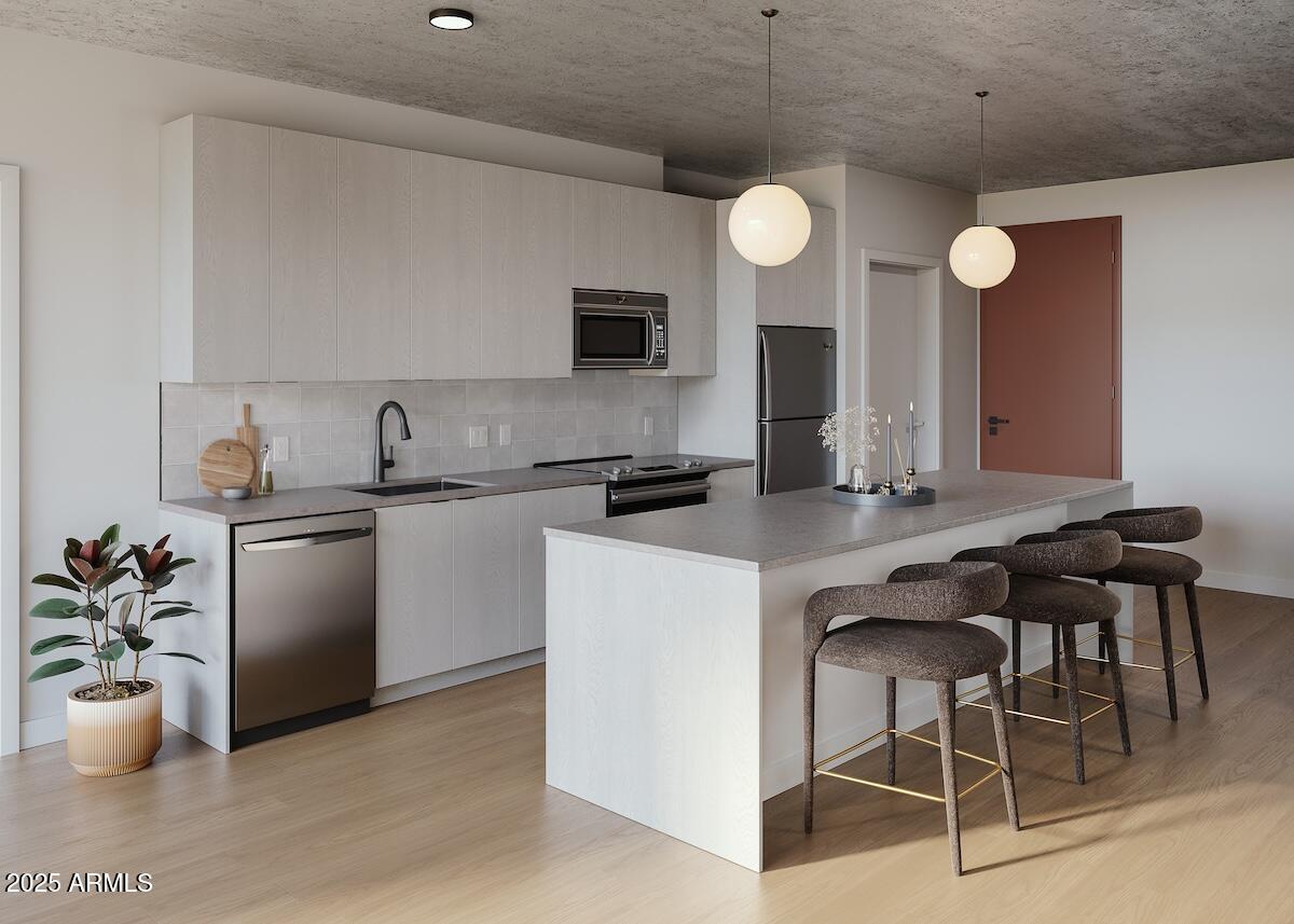 50 East Fillmore Street Phoenix, AZ 85004 - Photo 23 of 33 a kitchen with a table and chairs in it