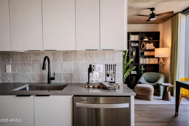 a kitchen with stainless steel appliances granite countertop a lot of cabinets a stove and a wooden floors