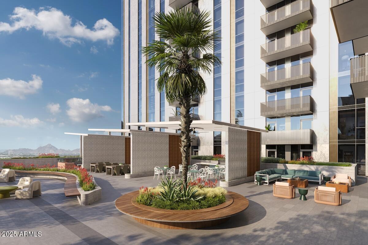 50 East Fillmore Street Phoenix, AZ 85004 - Photo 6 of 33 a view of a patio with dining table and chairs potted plants