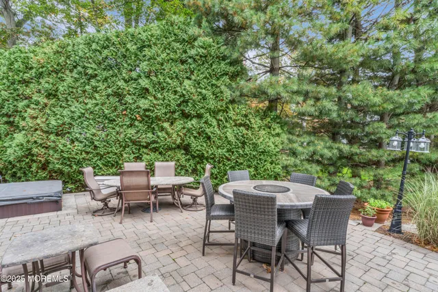 a view of a patio with table and chairs and potted plants