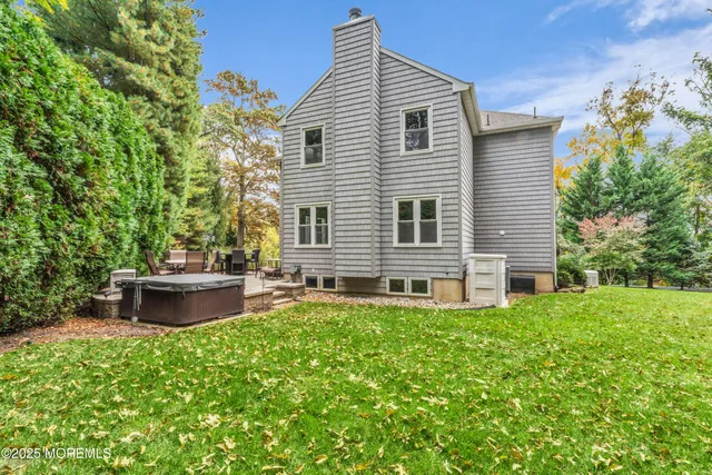 a view of a house with a yard and sitting area