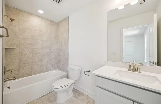 a bathroom with a sink a toilet and a bathtub