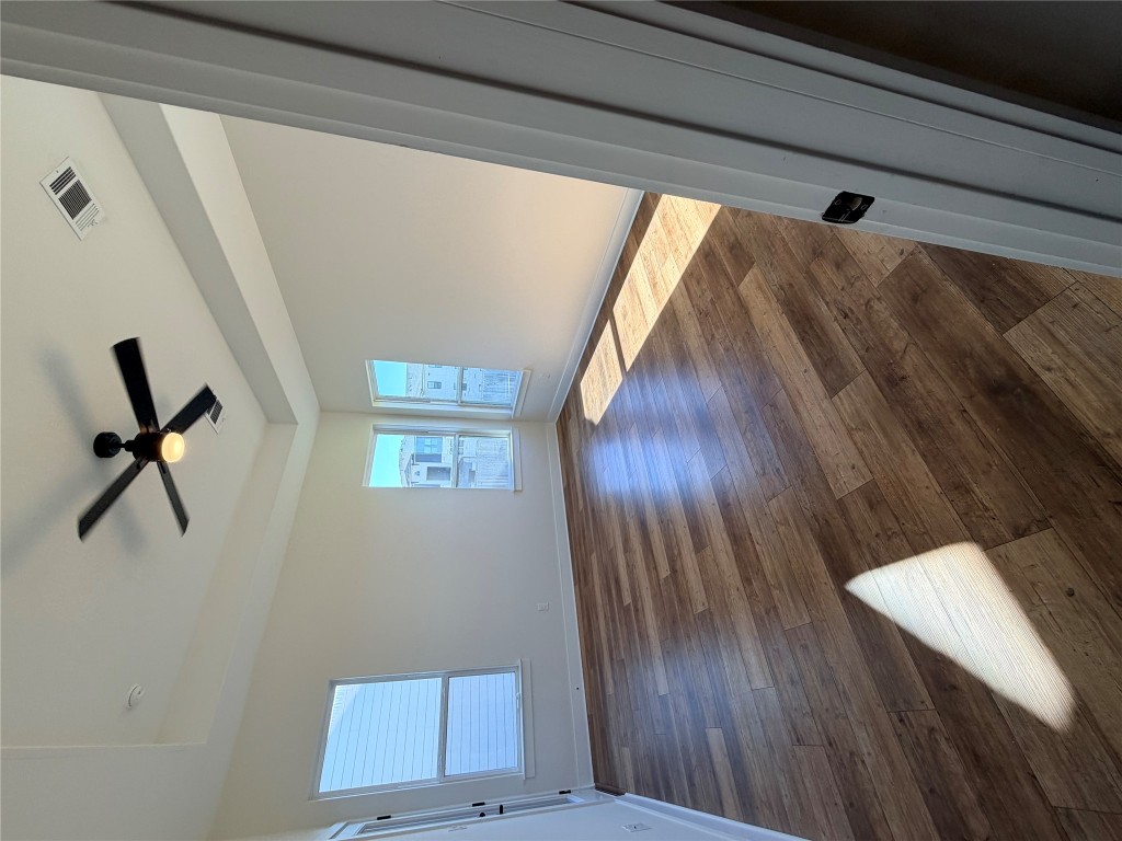 8604 Torrita Drive Round Rock, TX 78665 - Photo 9 of 26 a view of empty room with wooden floor and fan