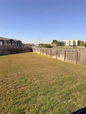 a view of an empty room with window and stairs