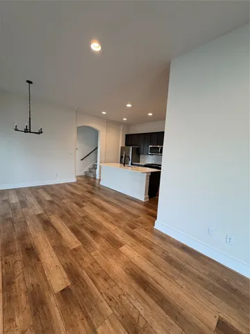 a view of a kitchen with a sink and a refrigerator