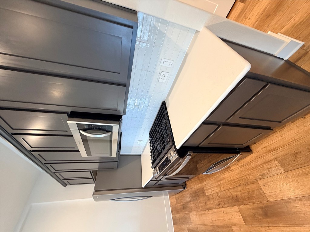 8604 Torrita Drive Round Rock, TX 78665 - Photo 6 of 26 a kitchen with stainless steel appliances granite countertop a stove a sink and a refrigerator