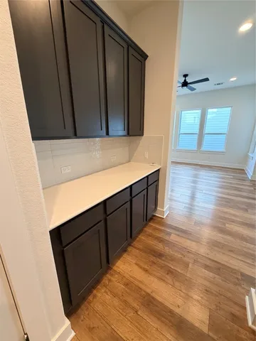 a view of hallway with wooden floor