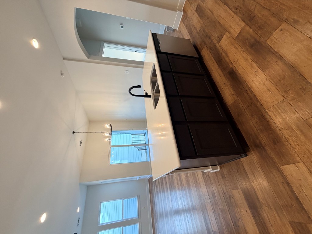 8604 Torrita Drive Round Rock, TX 78665 - Photo 25 of 26 a living room with stainless steel appliances kitchen island granite countertop a sink and wooden floor
