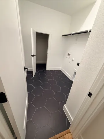 a living room with stainless steel appliances kitchen island granite countertop a sink and wooden floor