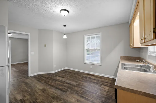 a view of a kitchen and a sink a window