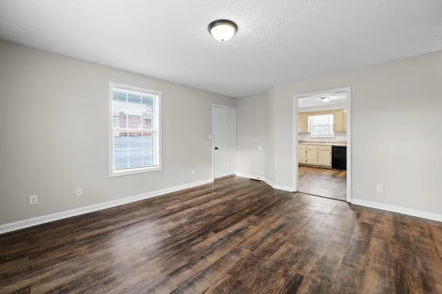 wooden floor in an empty room with a window