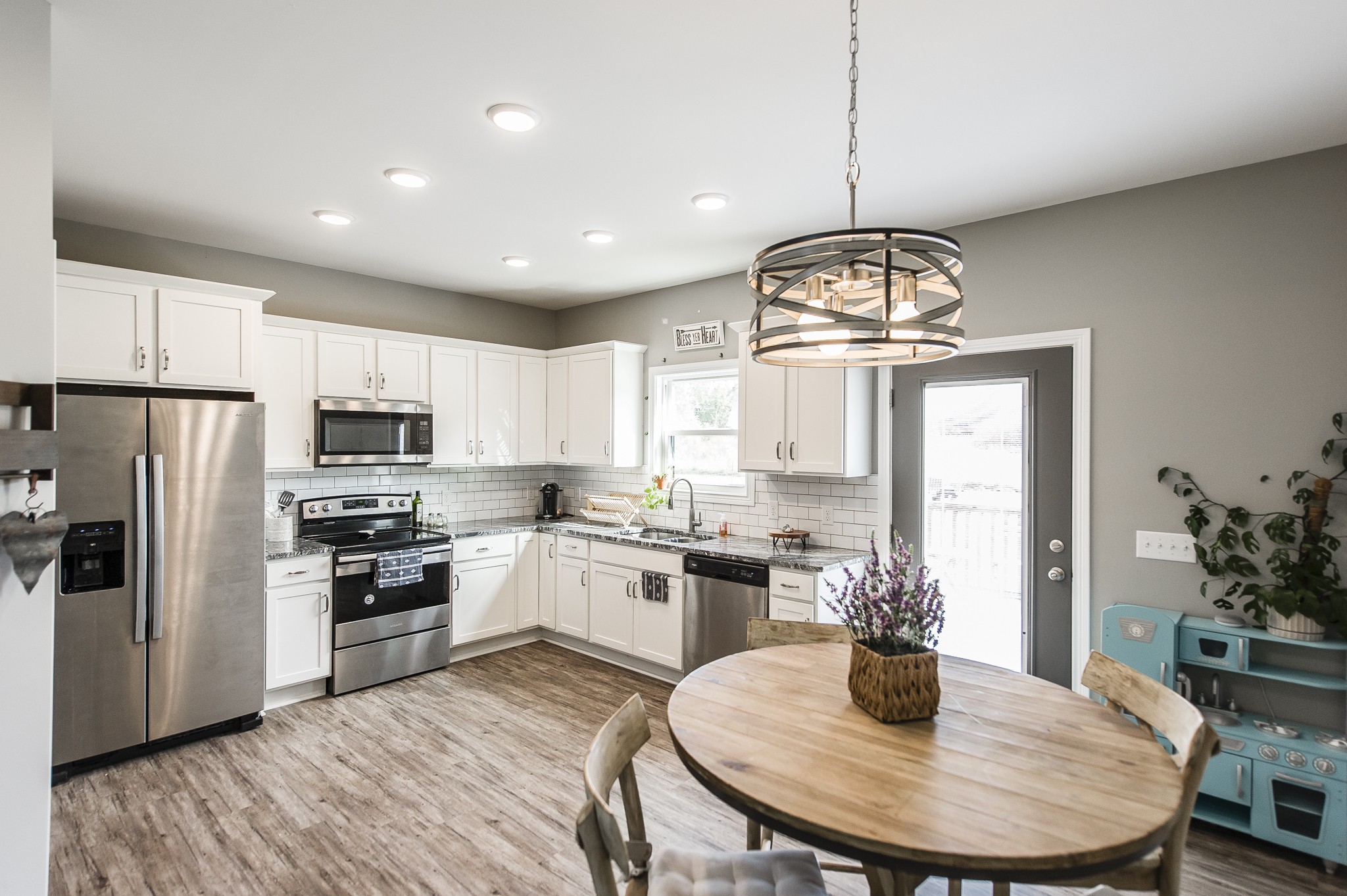 1502 Rock Bridge Road Bethpage, TN 37022 - Photo 10 of 37 a kitchen with microwave a stove a dining table and chairs