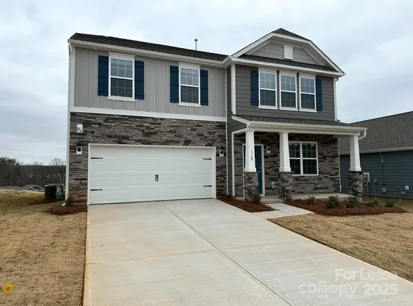 a front view of a house with parking space