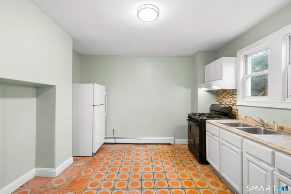 a kitchen with a sink appliances and cabinets