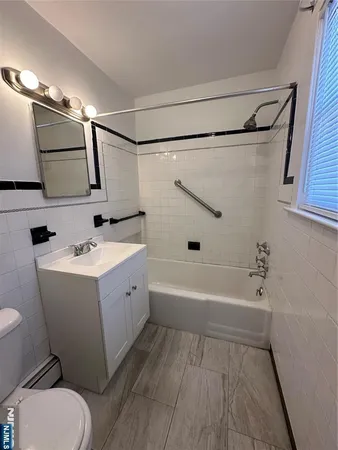 a bathroom with a sink mirror toilet and bathtub