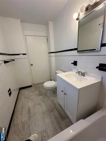 a bathroom with a sink toilet and mirror