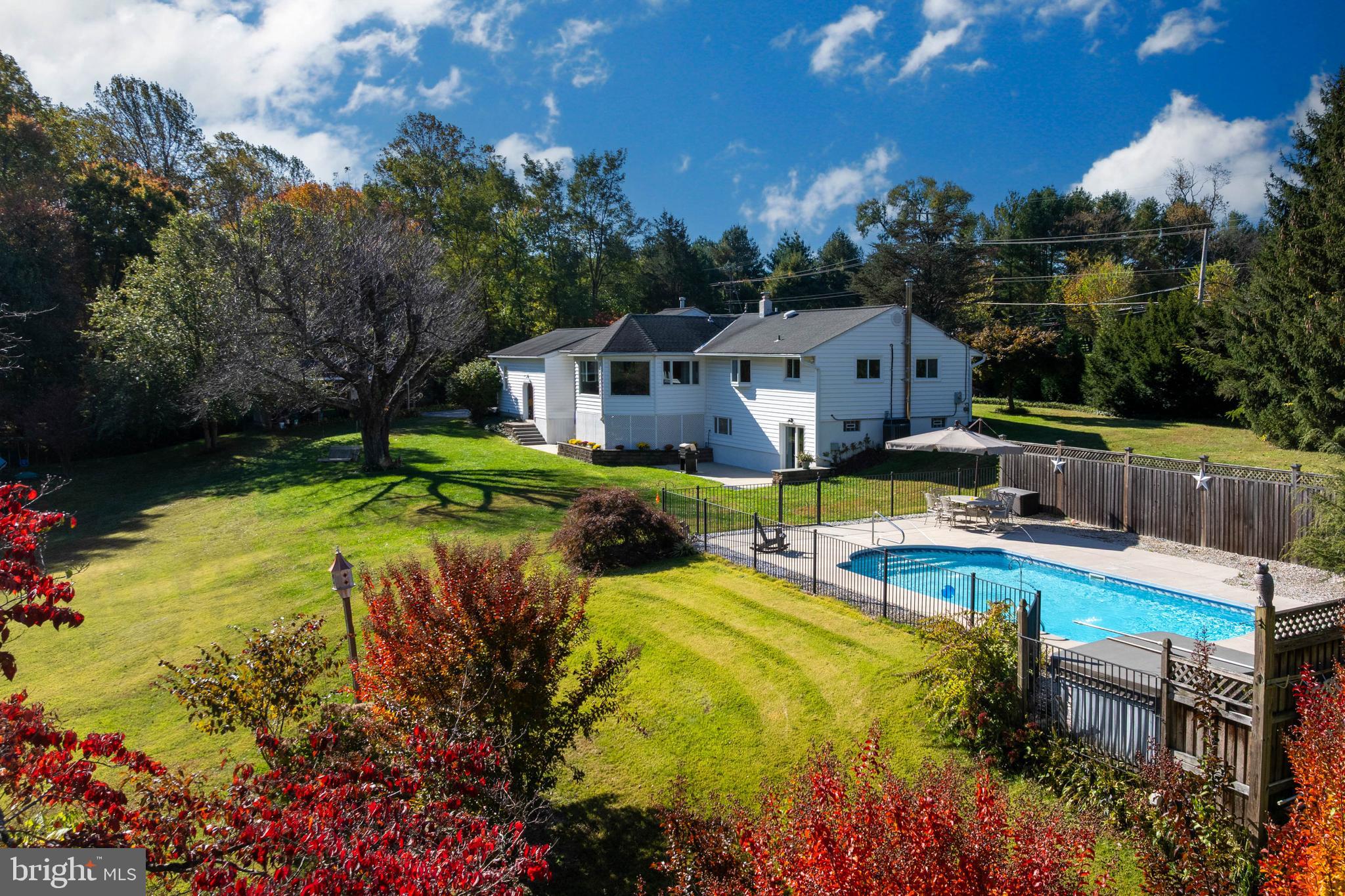 a view of a house with swimming pool and sitting area