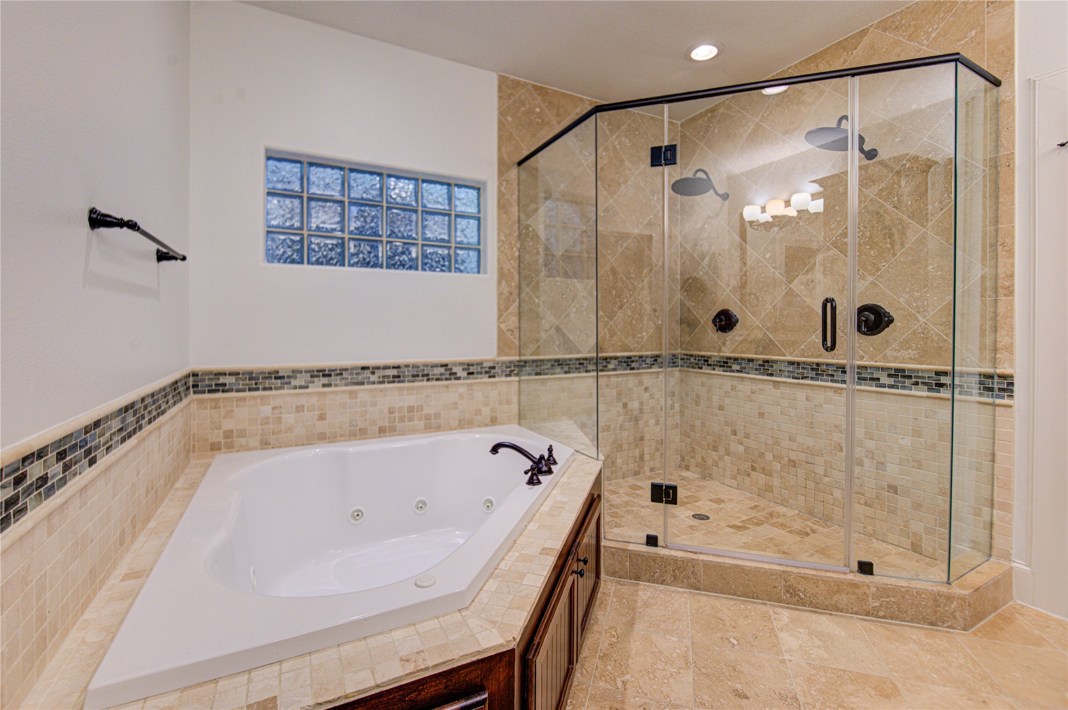 6520 Rodrigo Street Houston, TX 77007 - Photo 24 of 44 Primary bathroom featuring a jetted soaking tub, oversized glass-enclosed shower, and tile finishes throughout.