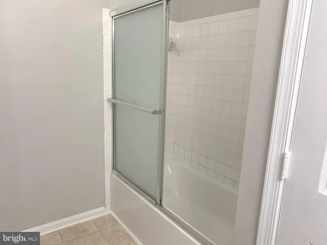 a bathroom with a glass shower door