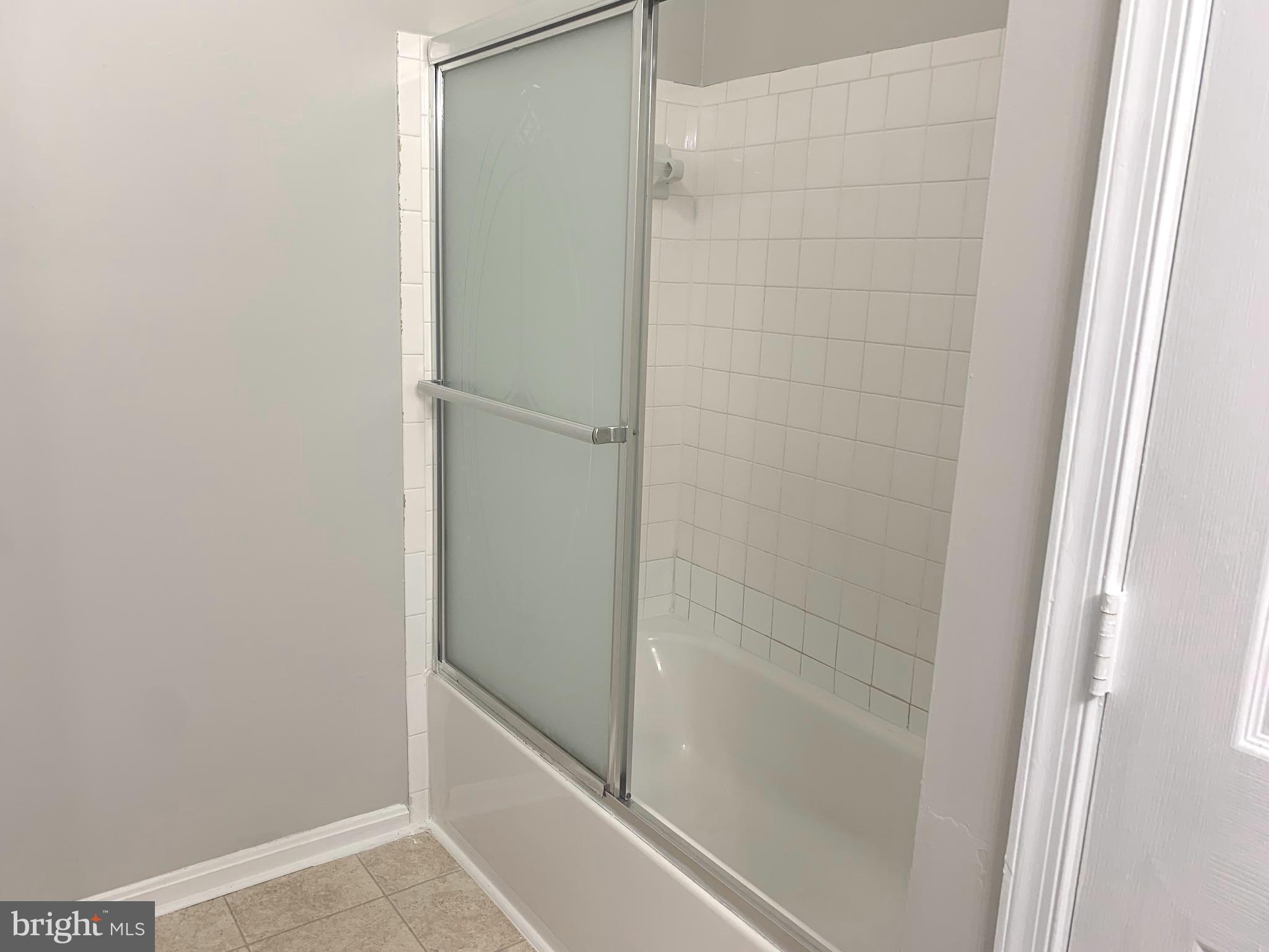 224 Gentlebrook Road Owings Mills, MD 21117 - Photo 14 of 24 a bathroom with a glass shower door