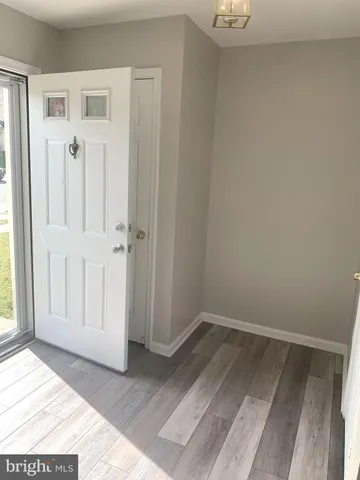 a view of a room with wooden floor and a window