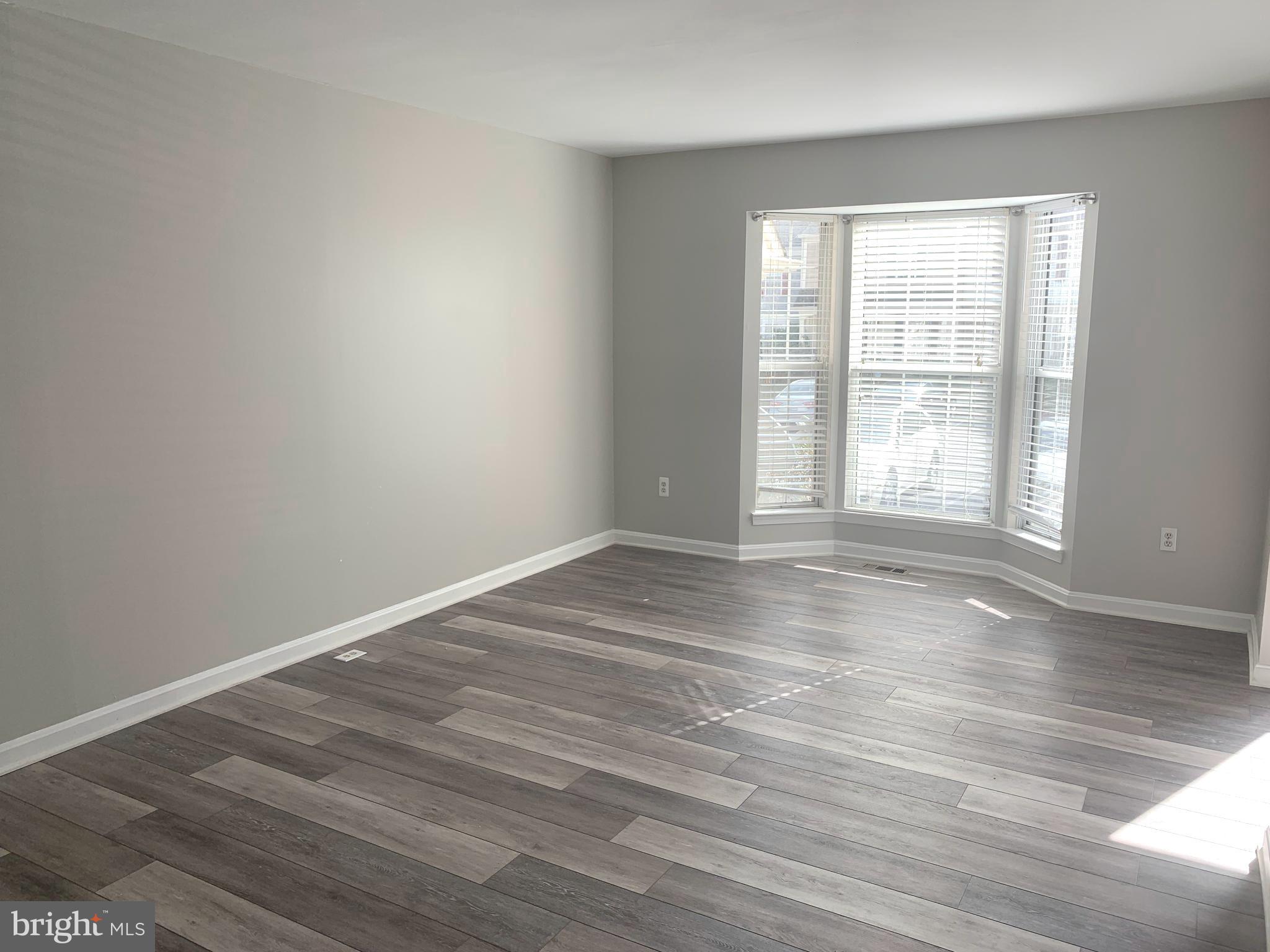224 Gentlebrook Road Owings Mills, MD 21117 - Photo 4 of 24 wooden floor in an empty room with a window