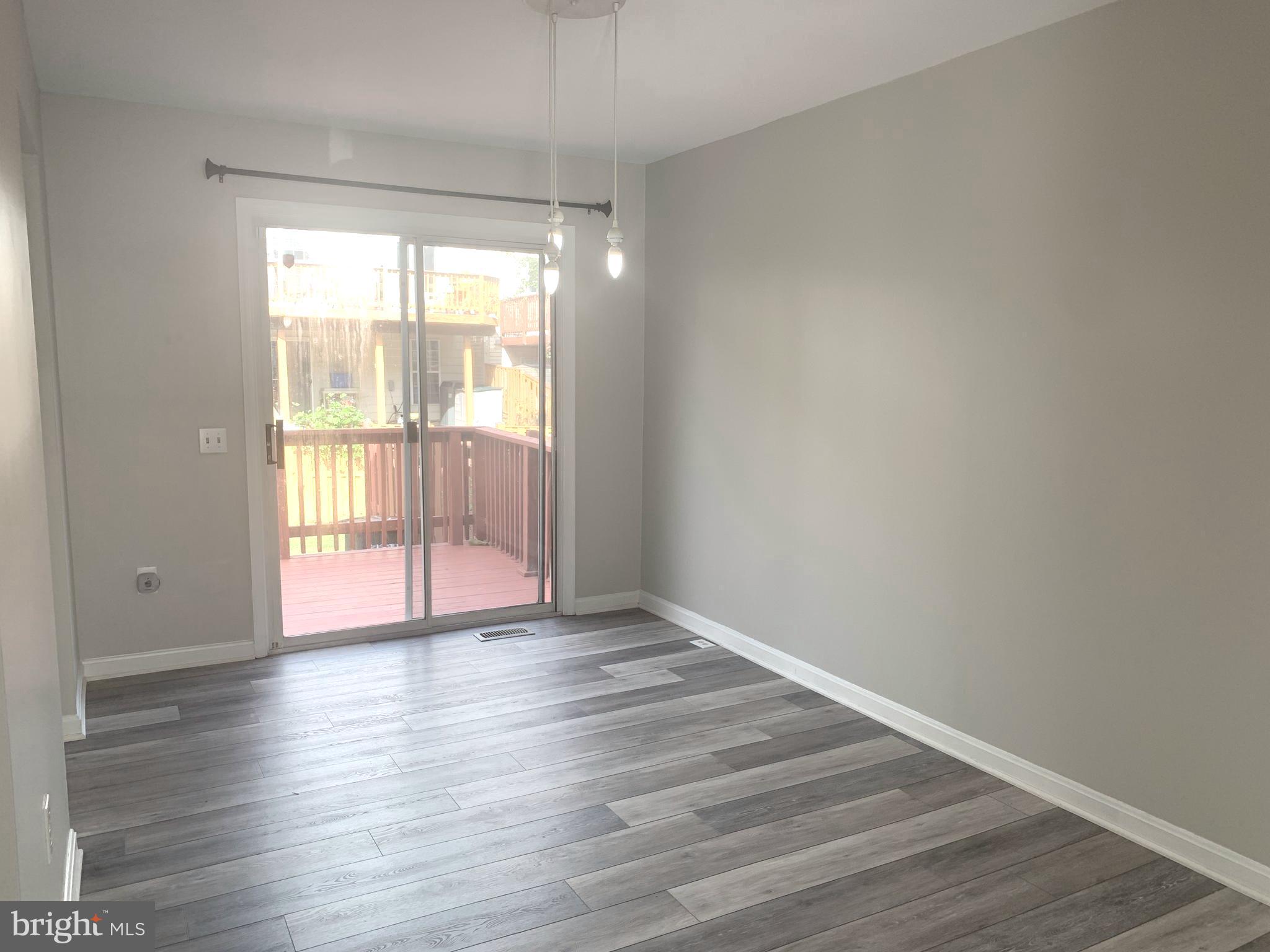 224 Gentlebrook Road Owings Mills, MD 21117 - Photo 6 of 24 a view of an empty room with wooden floor and a window