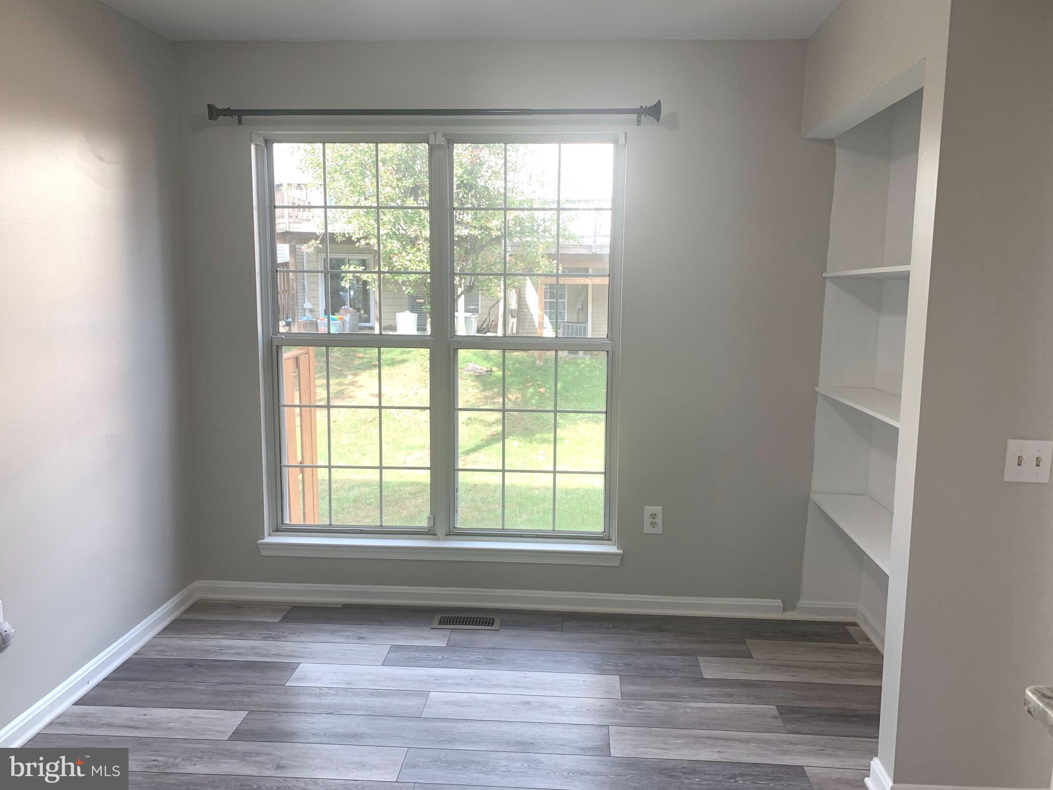 224 Gentlebrook Road Owings Mills, MD 21117 - Photo 9 of 24 a view of an empty room with wooden floor and a window