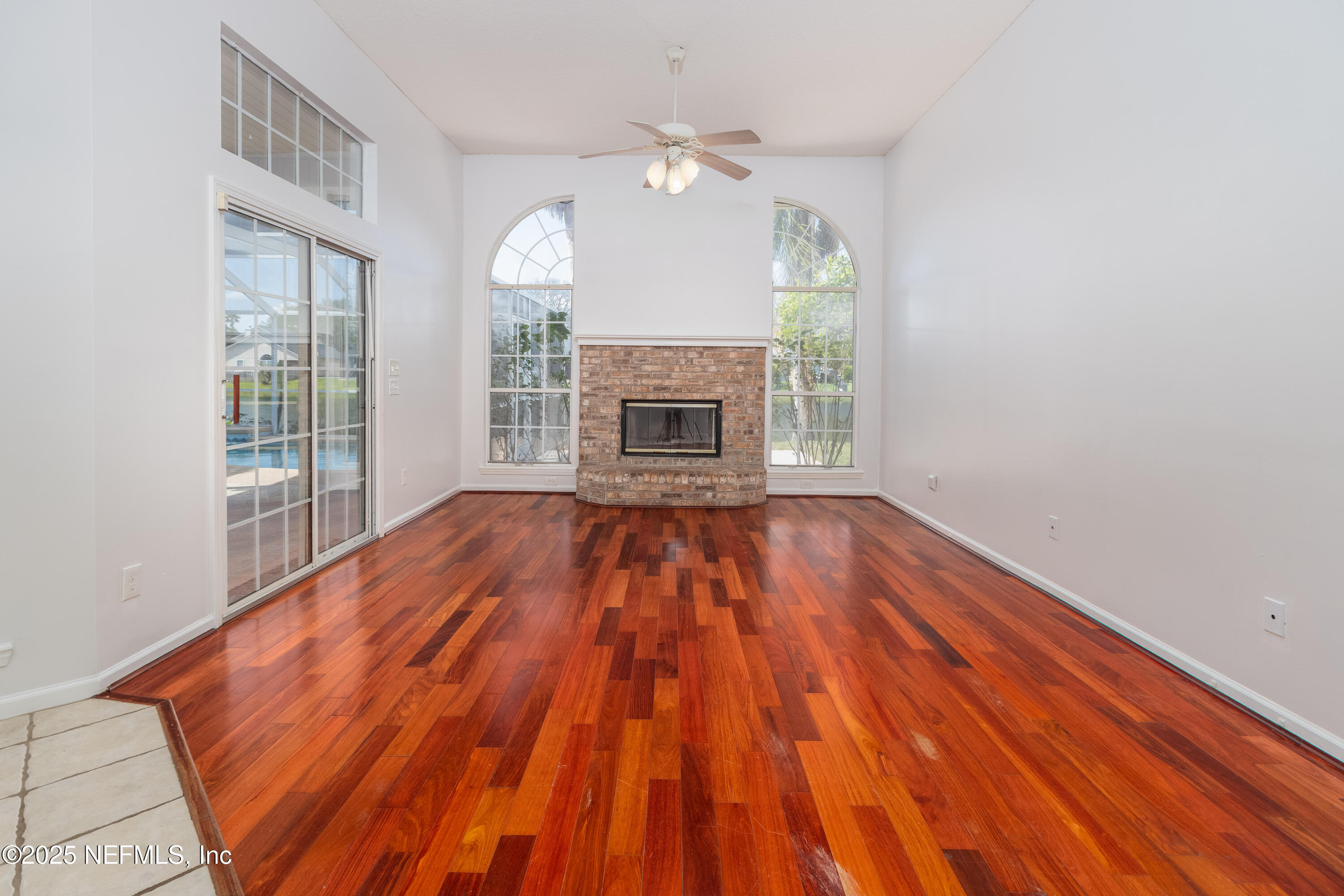 13775 Danforth Drive South Jacksonville, FL 32224 - Photo 18 of 38 a view of empty room with wooden floor and fireplace