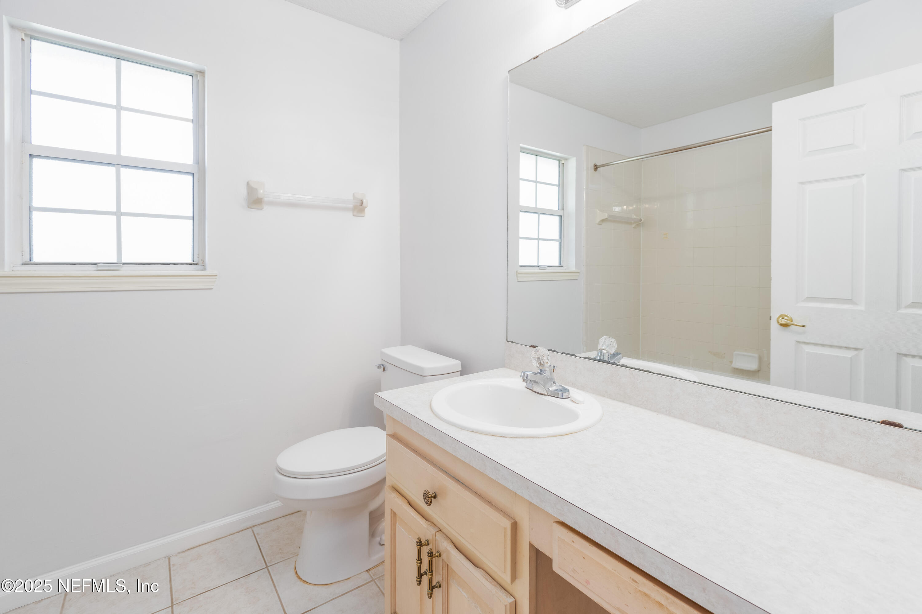 13775 Danforth Drive South Jacksonville, FL 32224 - Photo 21 of 38 a bathroom with a sink a toilet and window