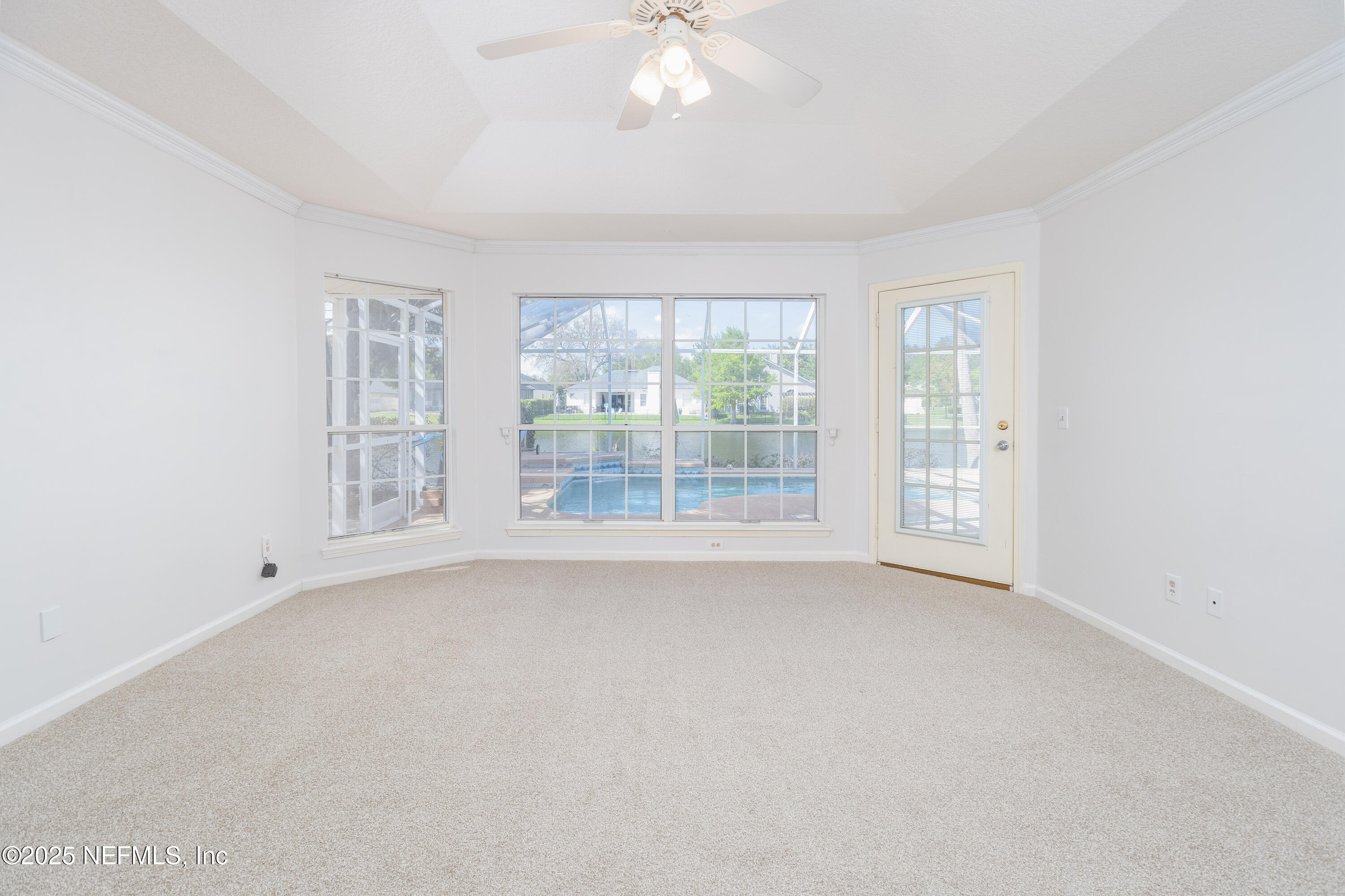 13775 Danforth Drive South Jacksonville, FL 32224 - Photo 24 of 38 an empty room with windows and chandelier fan