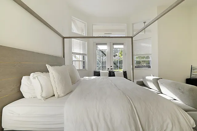 a bedroom with a large bed and a large window