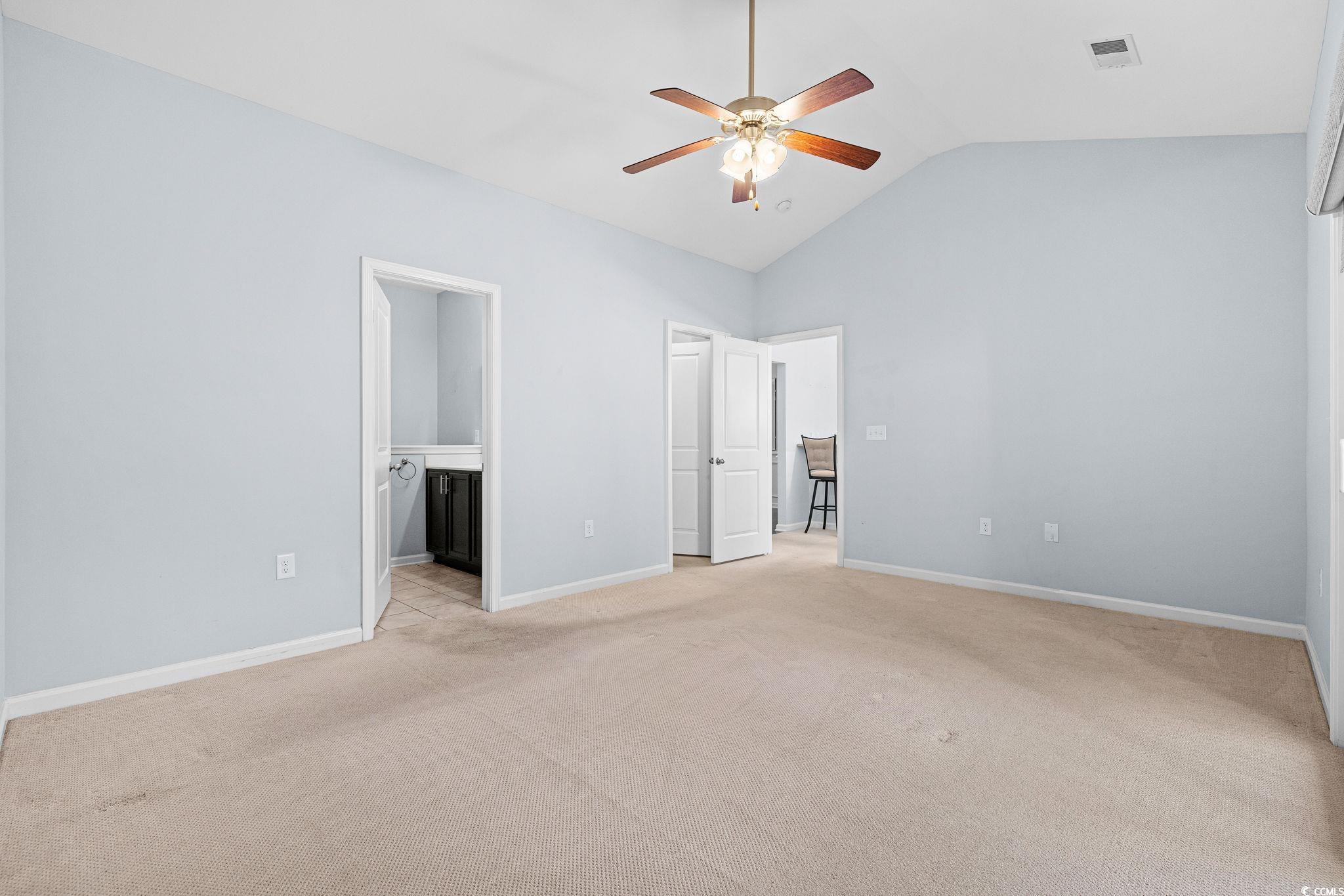 817 Arezzo Way, Unit 1001 Myrtle Beach, SC 29579 - Photo 23 of 40 Unfurnished bedroom with light carpet, ensuite bathroom, a ceiling fan, and high vaulted ceiling