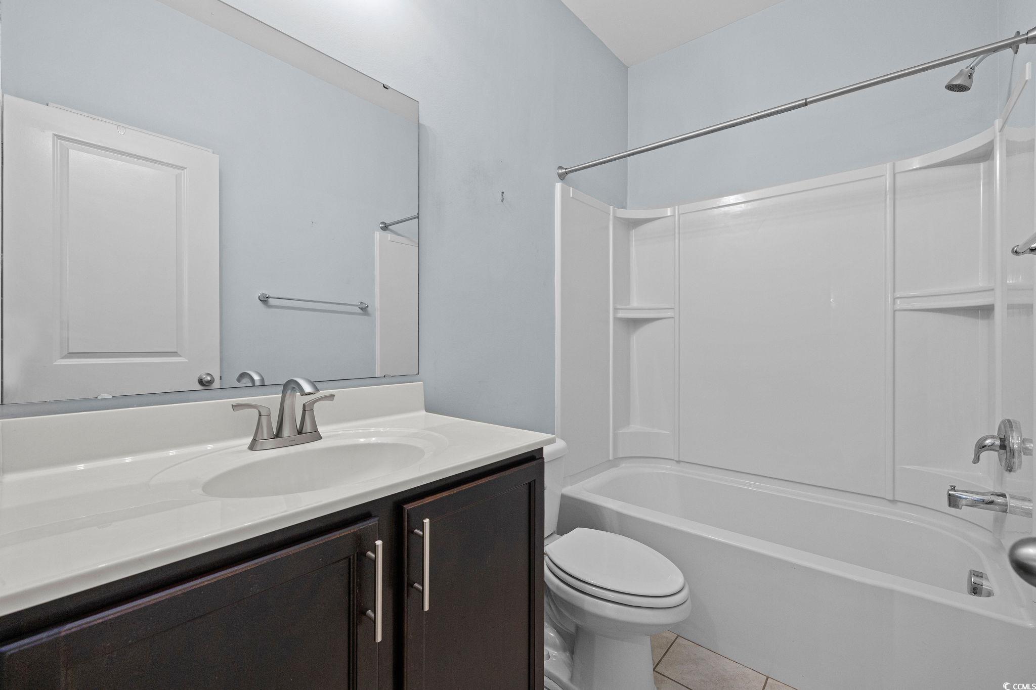 817 Arezzo Way, Unit 1001 Myrtle Beach, SC 29579 - Photo 28 of 40 Bathroom featuring washtub / shower combination, light tile patterned floors, and vanity